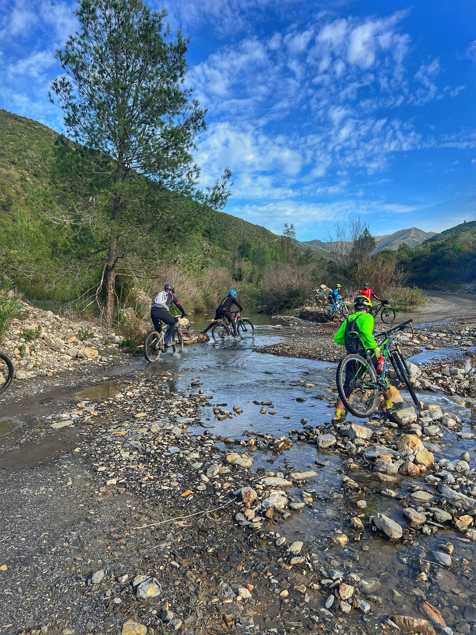 Cyclists crossing a mountain stream